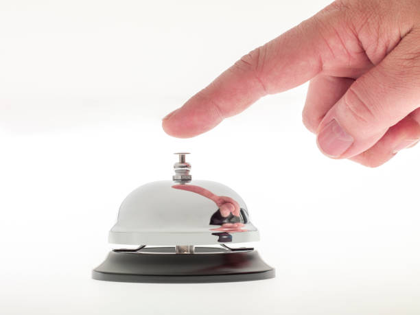 istock Man hand ringing a reception bell.Studio shot on a white background. No people. 1801798629
