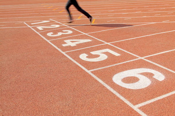 istock Walking man legs on runway in a sports ground 1801825337