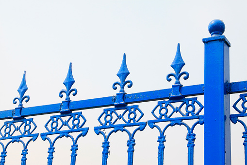 blue wrought iron fence, closeup of photo
