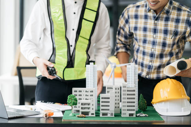 istock Engineer teams meeting working together wear worker helmets hardhat on construction site. Asian industry professional team. 1801846195