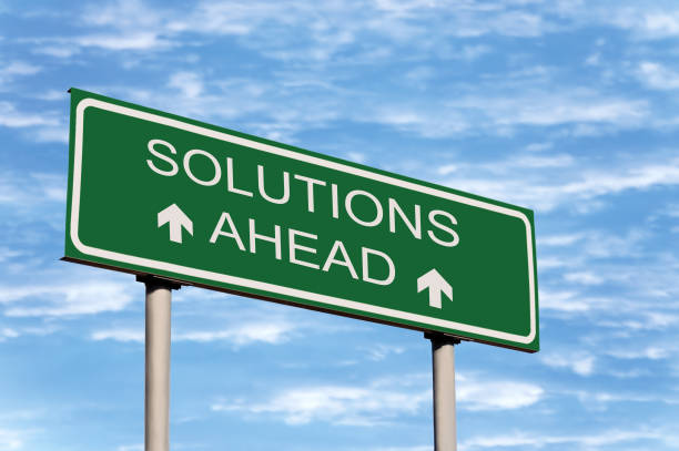 istock Solutions Ahead Road Sign Concept, Green Roadside Ad Signage, Grey Billboard Pole Posts, White Frame, Large Detailed Horizontal Closeup, Bright Blue Summer Cloudscape Sky Clouds 1801863162