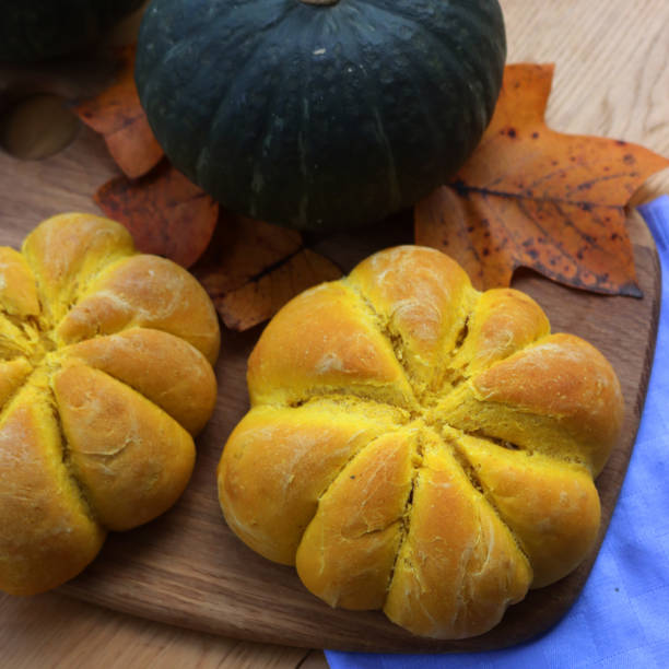 istock Orange pumpkin shaped 
 buns on table with fresh Delica pumpkin 1801872291