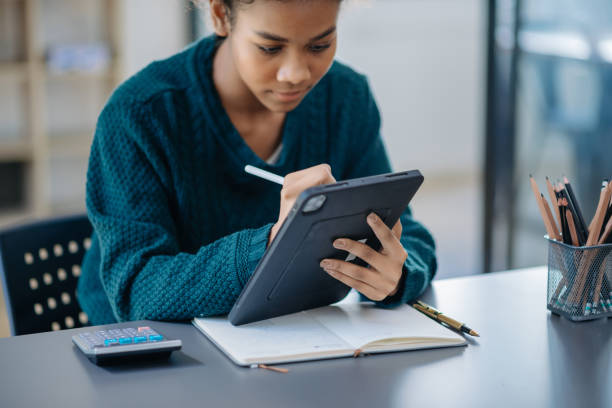 istock African businesswoman working in the office with working notepad, tablet and laptop documents 1801874498
