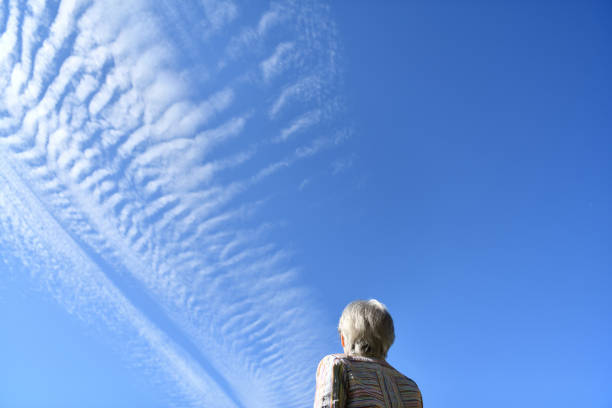 istock Senior woman looking at the blue sky 1801901331