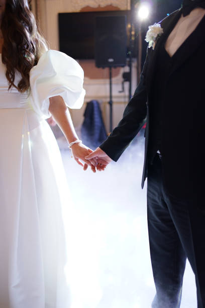 istock During the wedding ceremony, the newlyweds hold hands illuminated by the light effect. 1801907258