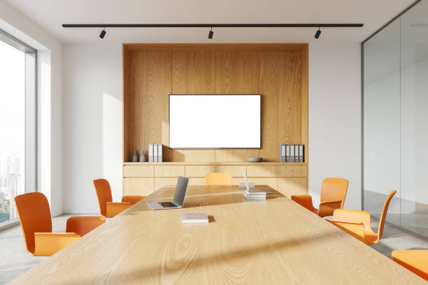 istock Cozy office conference room interior with meeting table and mock up tv display 1801908892