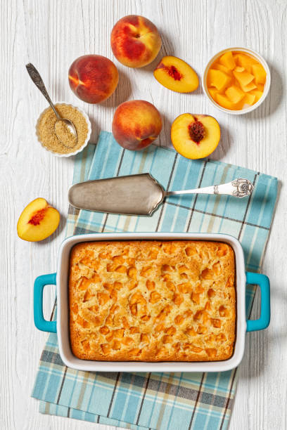 istock peach cake in baking dish on dark wooden table 1801912101