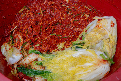 The process of making a traditional Korean dish, kimchi. Close-up of a salted cabbages and seasonings for kimchi
