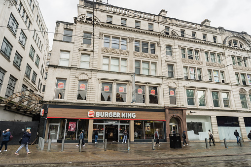 Manchester, England, October 5th 2023. A Burger King fast food restaurant occupies the ground floor of a classic, ornately decorated building.