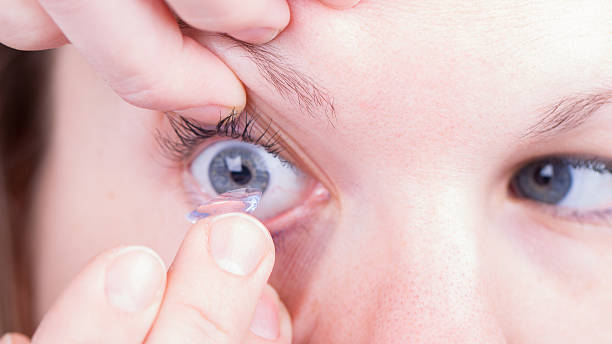 istock Woman holds a Contact Lens 180193176