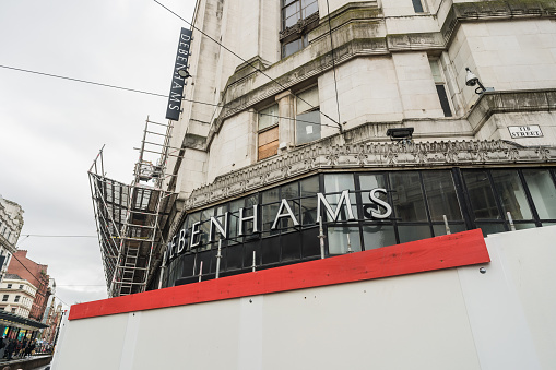 Manchester, England, October 5th 2023. Closed Debenhams store with prominent signage. Construction scaffolding is visible on the side.