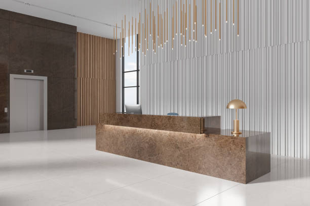 istock Stylish hotel interior reception desk, pc computer and lift near window 1801932703