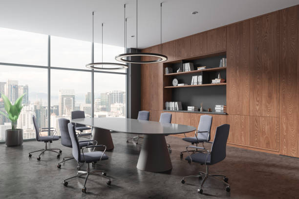istock Stylish office room interior with meeting board and armchairs, panoramic window 1801932719