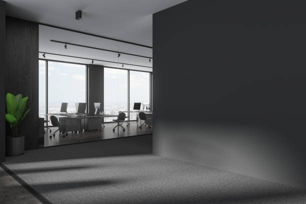 istock Grey office interior with pc monitors and armchairs, window. Mock up wall 1801935833