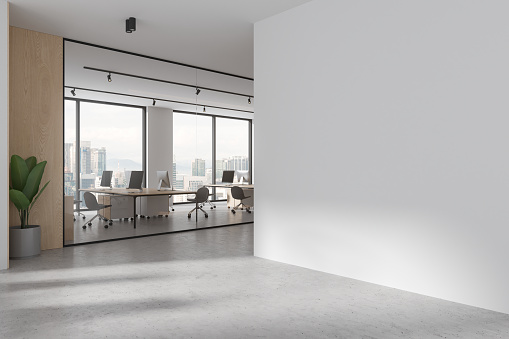 White glass coworking interior with pc desktop and chairs in row, side view business hallway. Panoramic window on Kuala Lumpur skyscrapers. Mockup empty wall partition. 3D rendering
