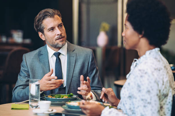 istock Business persons having a conversation during lunch 1801938969