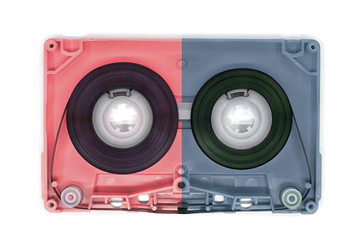 two color old audio cassette tape open on white background