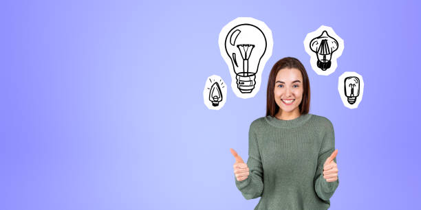 istock Cheerful thumb up woman student and light bulbs 1801943801