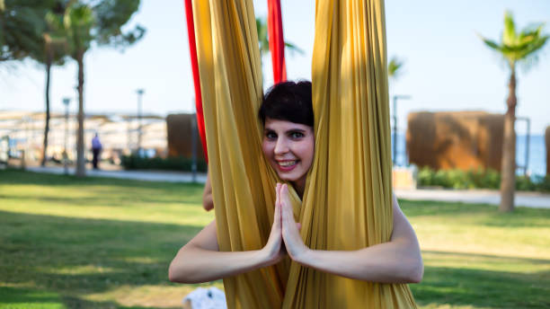 istock A woman took a yoga pose while doing aerial gymnastics on fabrics 1801952707