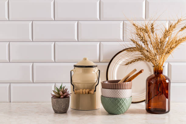 istock Trendy kitchen utensils and decorative vase with dry branches on stone countertop in modern kitchen interior. Front view. A copy of the space. 1801960844
