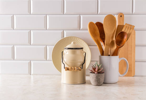 Stylish kitchen background in light colors with stylish kitchen utensils in a minimalist style. Front view. A copy of the space. White brick wall