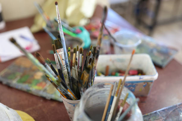 istock Glasses with brushes for painting at artist workplace 1801962659