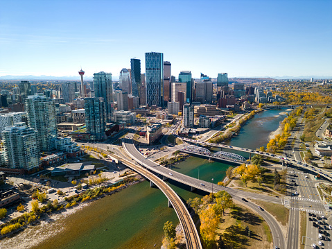 Downtown Calgary skyline and Bow River in autumn season. Aerial view of City of Calgary, Alberta, Canada.