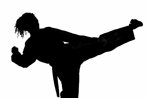 Silhouette of a young unrecognizable man dancing in an underground garage.