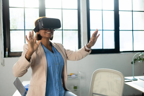 istock Businesswoman using VR glasses at her office 1801997079