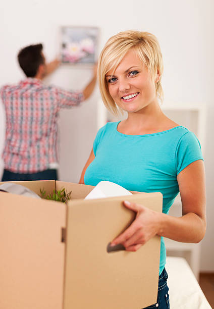 istock Woman carrying box with items for a new apartment 180202138