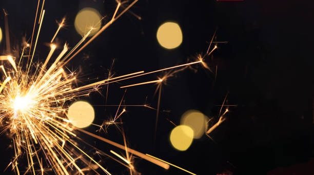 istock Burning sparkler with golden bokeh light background. 1802029885