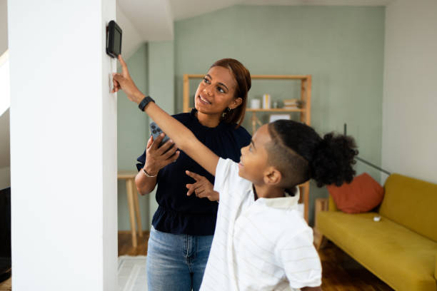 istock Boy and his mom turning on smart home system 1802039407