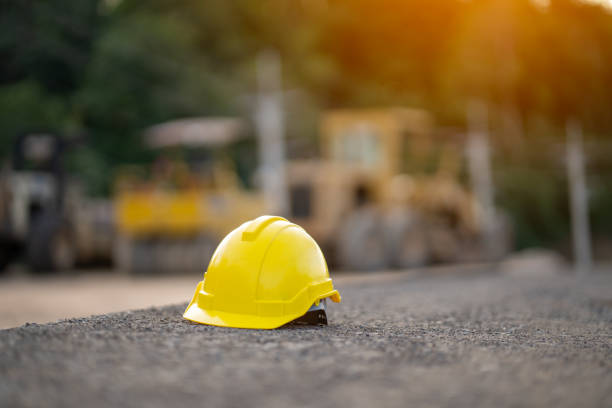 istock Safety helmets at construction site, road construction site background, safety concept 1802041022