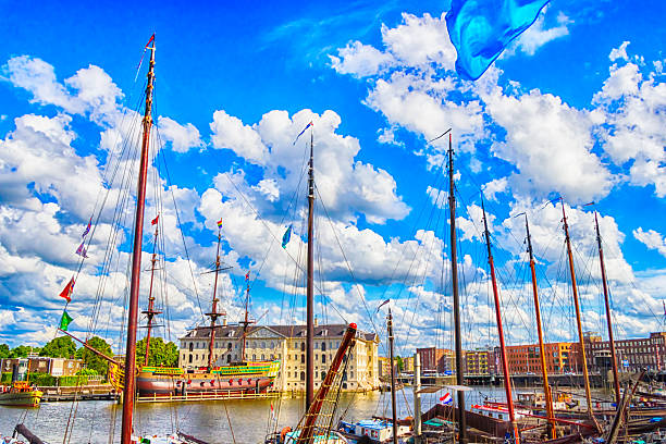 View of the Sea Palace floating Chinese restaurant and a small boat on the water in Amsterdam, the Netherlands. A famous attraction and unique architectural landmark in the Dutch capital.