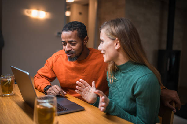 istock Diverse Couple in Dining Room Using Laptop 1802052038