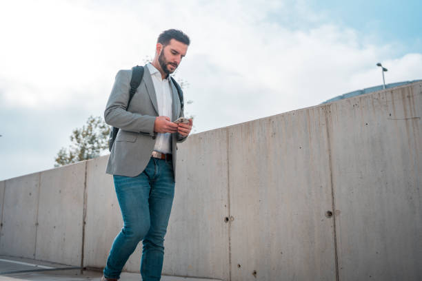 istock Caucasian Man Doing Online Banking on the Go Using Smartphone 1802053196