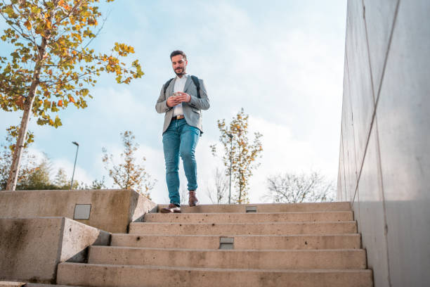 istock Caucasian Male on Stairs Using Smartphone 1802053717