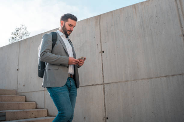 istock Caucasian Male on Stairs Using Smartphone 1802053721