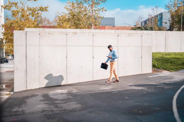 Indian Male Walking Outdoors Using Smartphone
