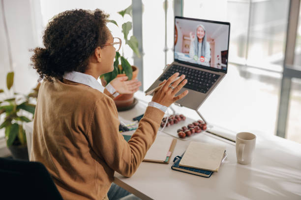 istock Smiling business woman have video conference with client while sitting in office 1802059190