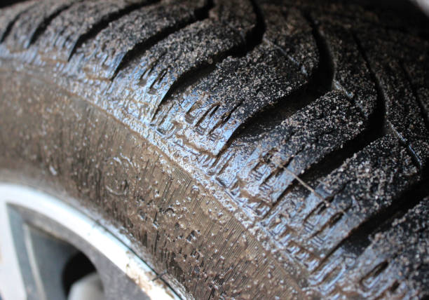 istock A car tire completely covered with a layer of liquid mud closeup view 1802059749