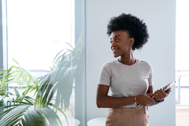 istock A Happy Black Female Corporate Worker Holding A Notebook And Looking Away 1802062229