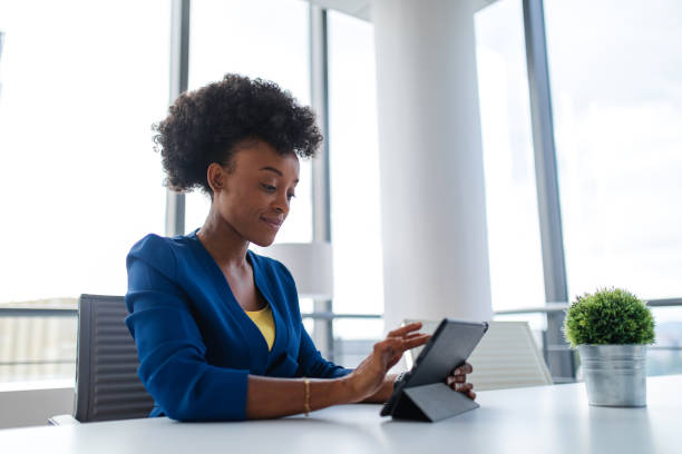 istock Black Female Financial Manager Going Over The Finances On Her Tablet 1802062755