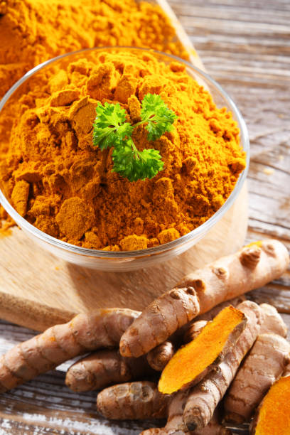 istock Composition with a bowl of ground turmeric and its fresh rhizome 1802065541