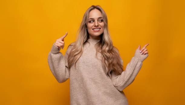 istock young woman pointing with her hands at the wall over isolated background 1802071938