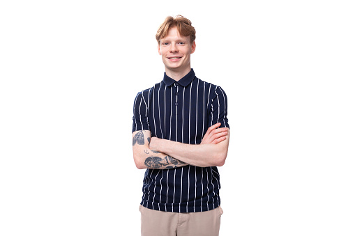 young European blond guy in a striped polo shirt on a white background.