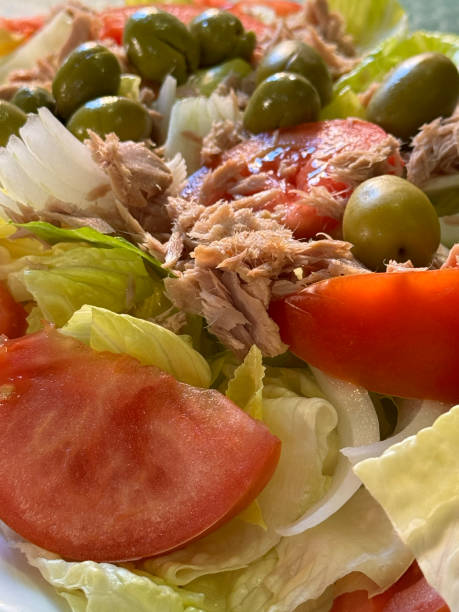 istock foreground appetizing salad with lettuce tomato tomato tuna onion and olives 1802149374