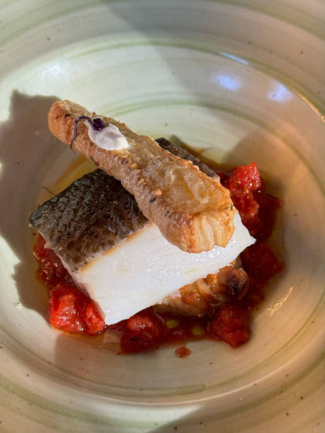 istock delicious cod with red bell pepper and toast dish 1802149392