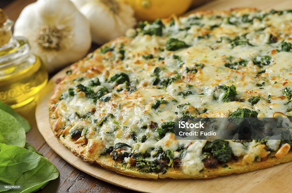 Spinach Pizza A freshly baked thin crust spinach pizza with garlic, lemons, and olive oil. Pizza Stock Photo
