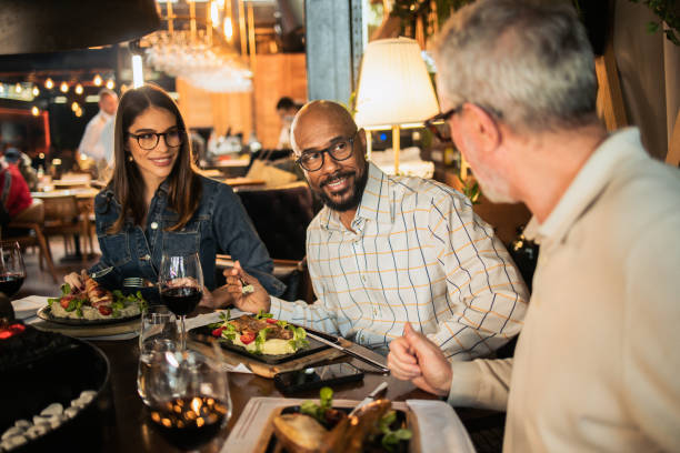 istock Business partners enjoying on a business lunch 1802150510